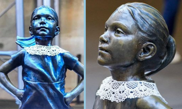 New York City, Wall Street Fearless Girl statue now wearing a lace collar to commemorate Justice Ruth bade Ginsburg.