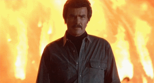 Burt Reynolds walking from an explosion.