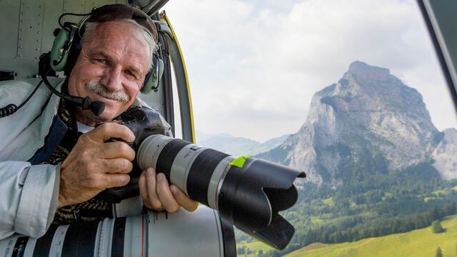 Yann Arthus-Bertrand in his usual spot with a camera.