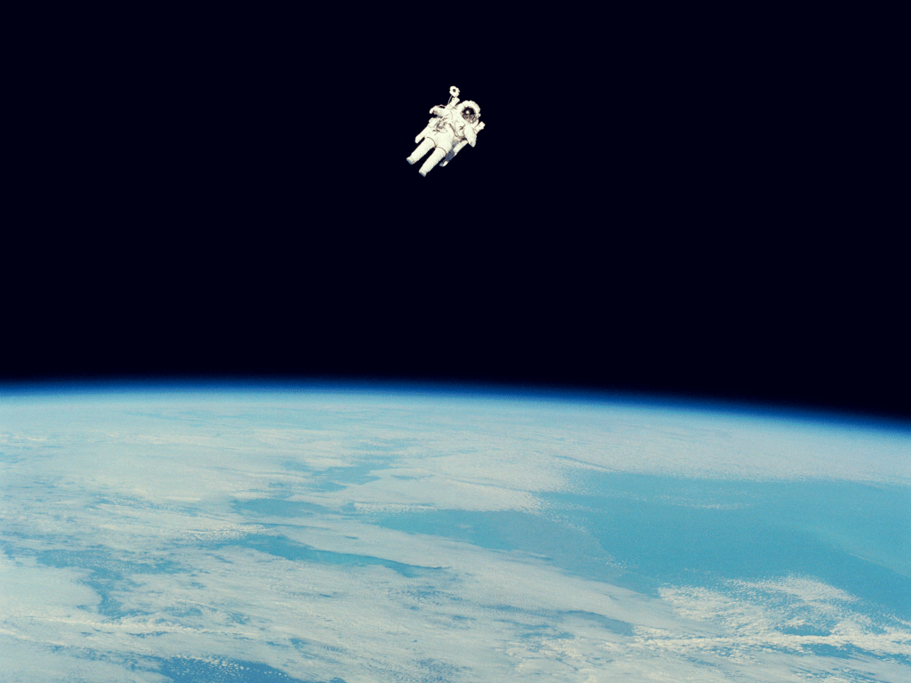 Astronaut floating above the earth.